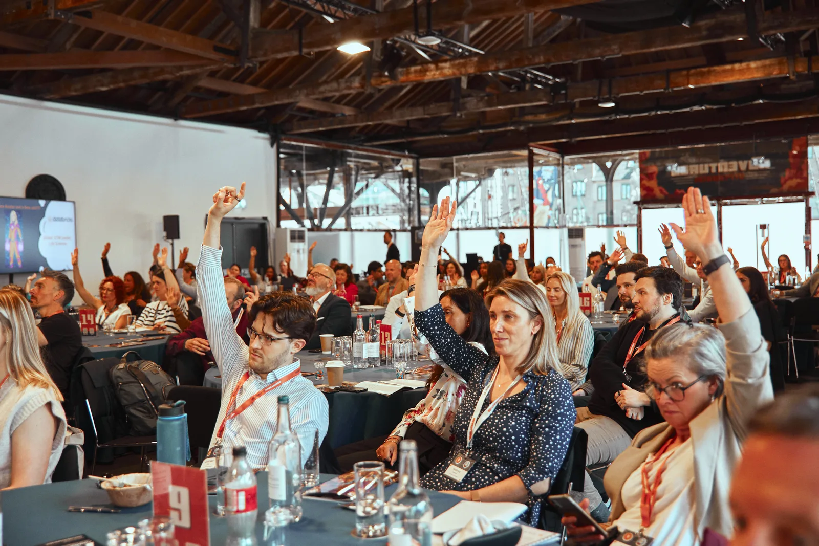 Attendees raising their hands during a live session